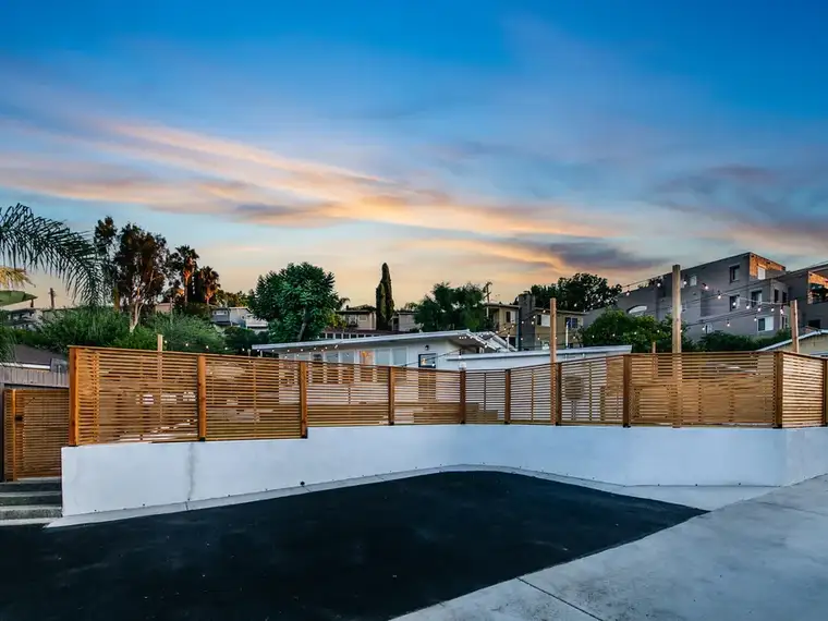 Calabasas outdoor living space with pavers and pool by Mi Casa Exteriors