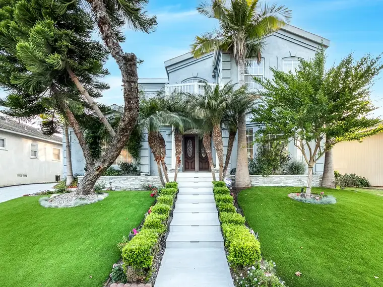 Drone view of a remodeled backyard with pavers, turf and a pool